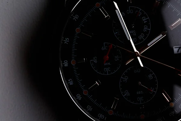 Close up front view of a modern wrist watch on the table. Soft focus. — Stock Photo, Image