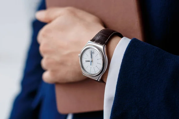 Hand of businessman with clock closeup — Stock Photo, Image