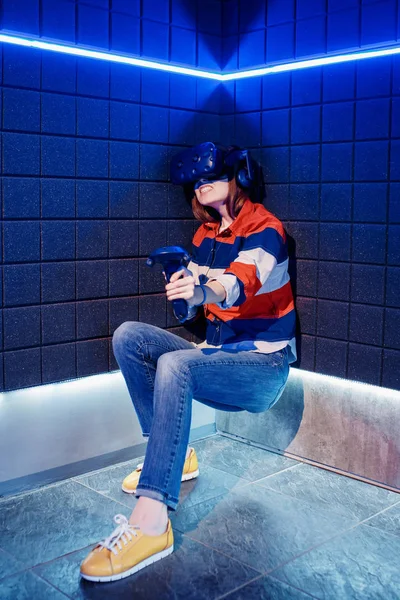 Girl in a virtual reality helmet scared