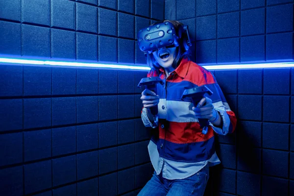 Girl in a virtual reality helmet scared