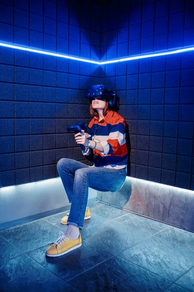 Girl in a virtual reality helmet scared