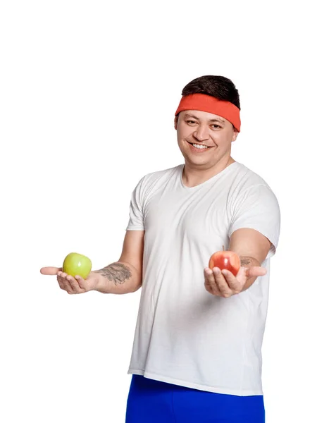 Χοντρός άνθρωπος σε λευκό φόντο με ένα μήλο στα χέρια του. άνθρωπος επέλεξε έναν υγιεινό τρόπο ζωής. — Φωτογραφία Αρχείου