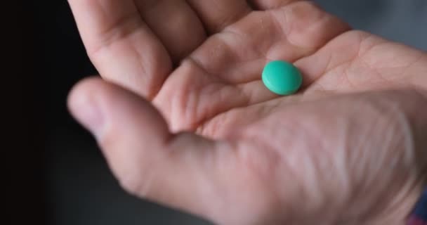 Man neemt medicijnen. de patiënt neemt de pillen met een glas water, zonder een gezicht — Stockvideo