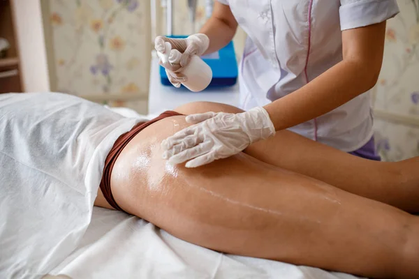 Tratamiento corporal: mujer que se somete a un procedimiento de elevación rf en las nalgas. Forma perfecta nalgas en el tratamiento anti-celulitis. masaje al vacío en las nalgas —  Fotos de Stock