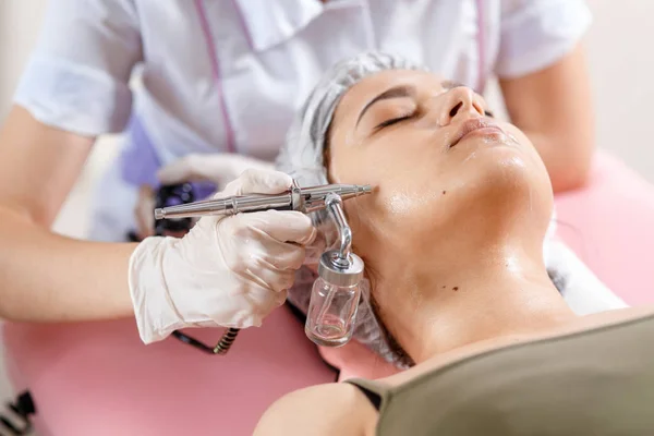 cosmetology beauty clinic.Professional cosmetologist conducts cell oxygenation for the face Ozone treatment with cosmetology apparat. Physiotheraphy. Lifting effect