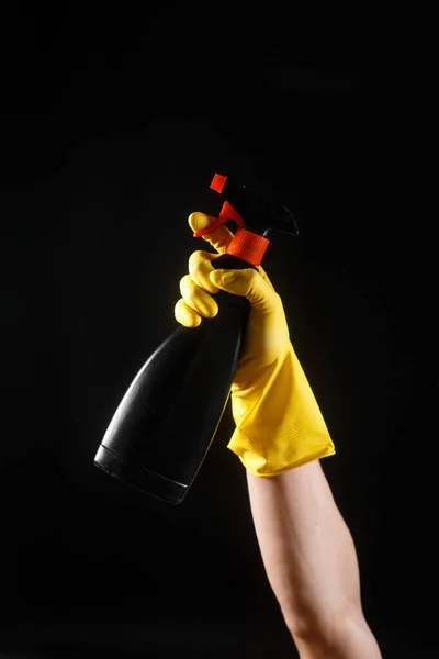 cleaning products, black wiper in hands with yellow rubber gloves