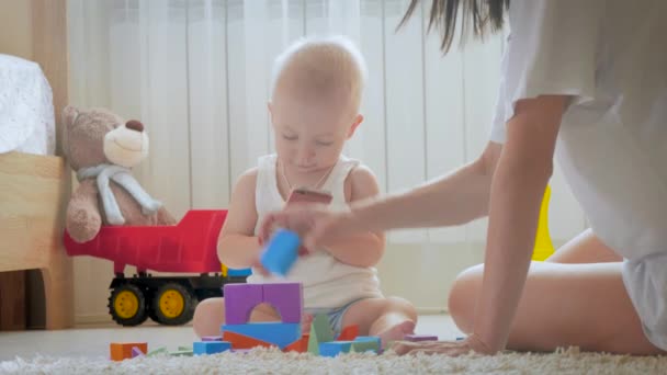 Mother And Her Kid Play With Toys Indoors Crawling Funny Baby Boy