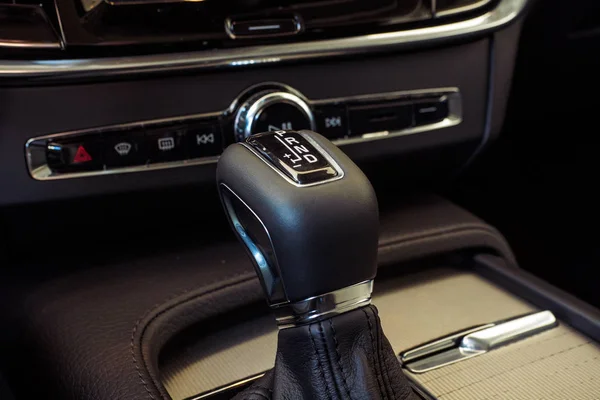 Automatic gear stick with manual selection option. Modern Luxury car inside. Interior of prestige modern car. Comfortable leather seats. Light brown perforated leather cockpit. Automatic gear stick shift.