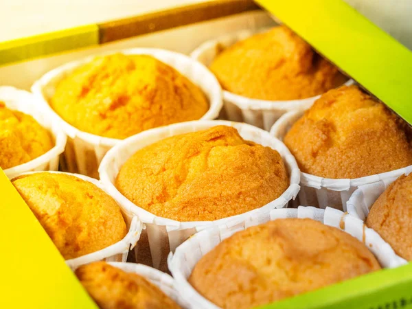 Vanilla muffins, paper cupcake holder, selective focus. Close-up photo of decorated homemade cupcakes in box. Gluten free almond flour muffin.