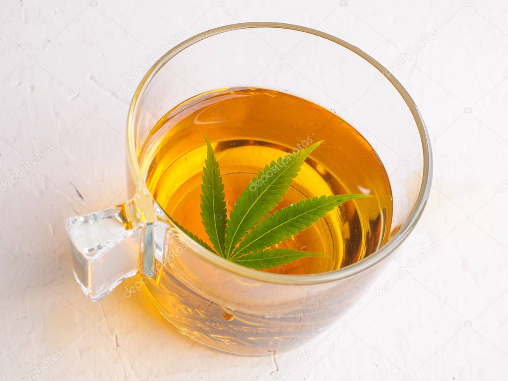 tea with marijuana. Cannabis leaf is brewed in herbal decoction to treat pain and increase appetite. concept of marijuana use for medicinal purposes.
