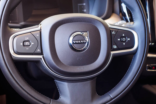 luxury car Interior - steering wheel and dashboard. Climate control, multimedia control and cruise control button. Volvo.