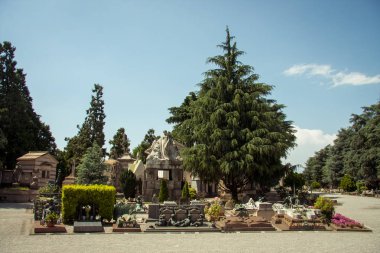CHELYABINSK, RUSSIA - June 07,2017 Milan, Italy. Famous landmark - old grave at the Monumental Cemetery (Cimitero Monumentale). Religious art. clipart