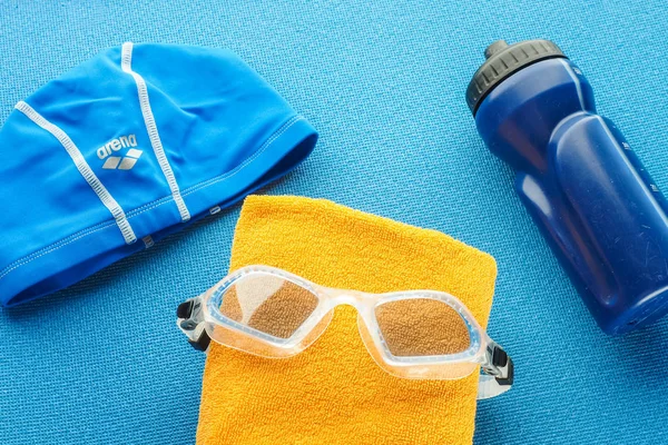 Flat lay composition with equipment for swimming pool  on blue b