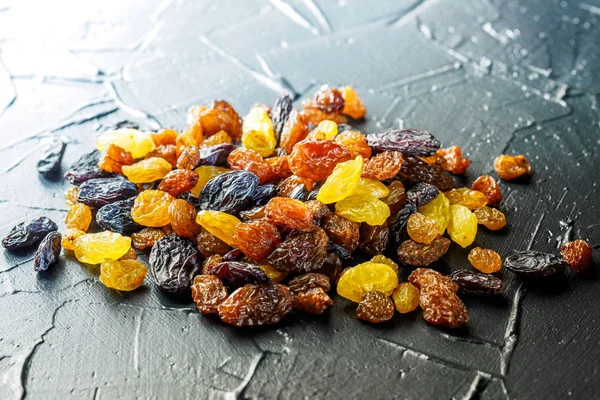 Assortment of Raisins, yellow, blue, black, golden raisin on dar