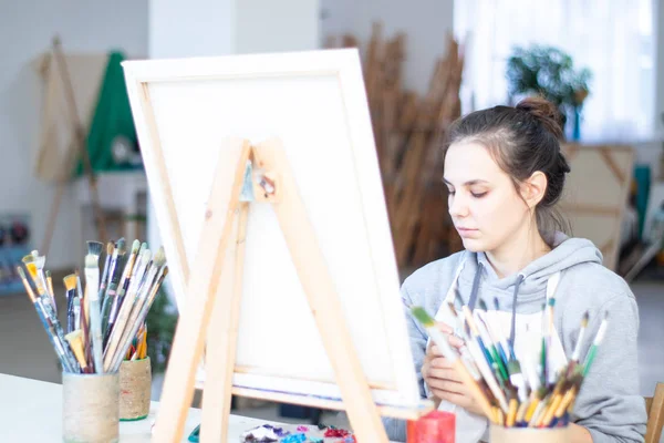 Girl artist paints a picture on canvas — Stock Photo, Image