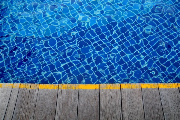 Swimming pool and Wooden flooring beside the pool ideal for back — Stock Photo, Image