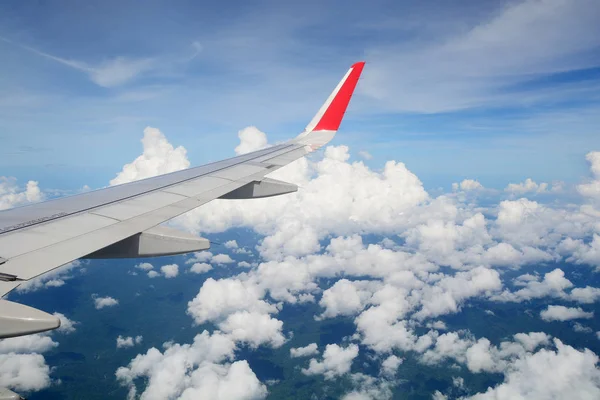 Aerial view Clouds and sky as seen through window of an aircraft — Stock Photo, Image