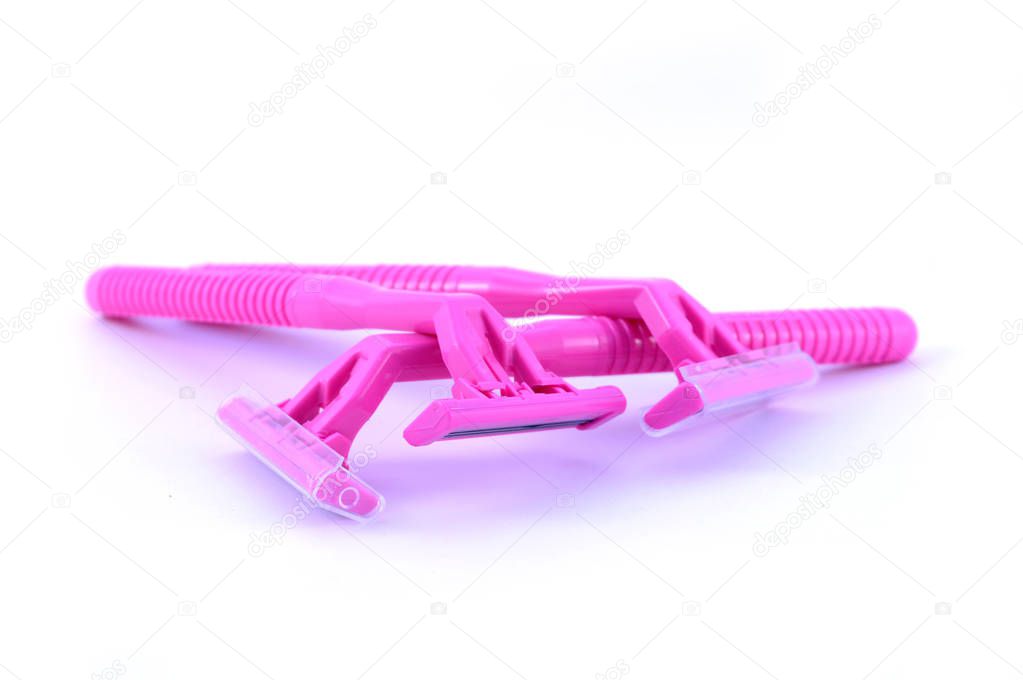 An isolated set of three new pink razors for womans hair removal.
