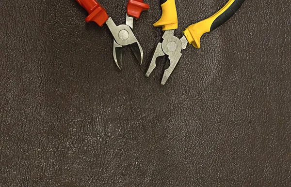 element of electrician tools pliers cutting pliers at the top of the decoration frame background dark copy space