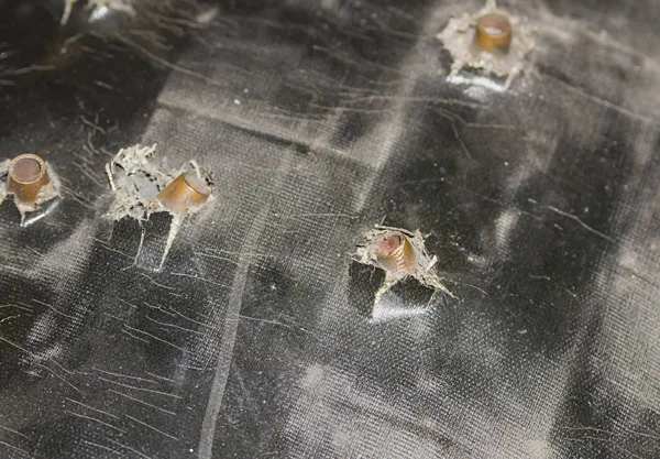 protection security stuck bullets in body armor theft assault set of stopped shells close-up on a dark background