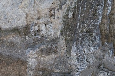 taş doku kaya doğal yıpranmış bölünmüş gri arka plan güneşli öğleden sonra arka plan taban tasarımı