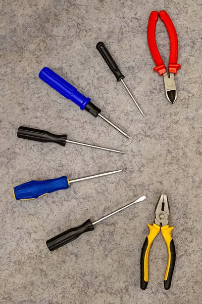 Tools group of screwdriver cutters repairing a home master design on a gray background design base — Stock Photo, Image