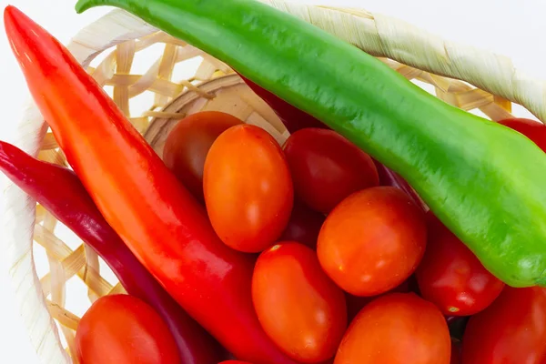 long peppers peppers green red mini cherry tomatoes closeup wicker basket background