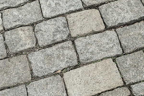 Azulejo piedra gris cuadrado desigual ciudad envejecida línea cuadrada patrón — Foto de Stock