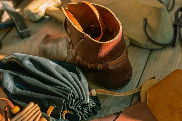 leather goods master reconstruction black wallet boots close-up tannery counter