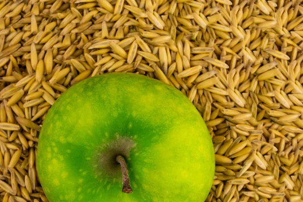 Смачні соковиті яблуко зелені фрукти крупним планом на тлі зерна пшениці — стокове фото