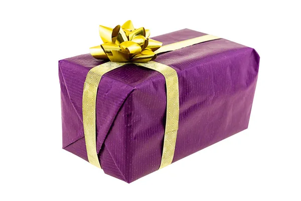 Giftbox lilac festive gift golden ribbon bow white background close up Stock Image