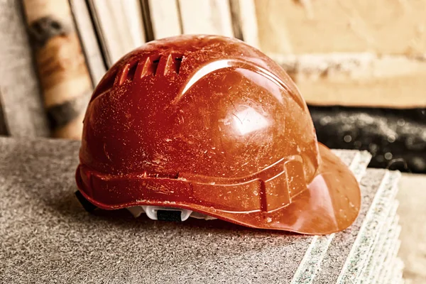 Helmet protective headgear worker safety side view of a wooden background