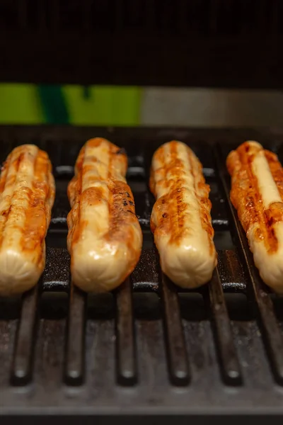 Appetizing chicken sausage close-up vertical photo on the grill background — Stock Photo, Image