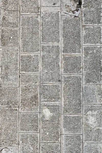 Сірий кам'яний фон візерунок з бруківки вертикальна основа суцільна міська територія вивітрюється — стокове фото