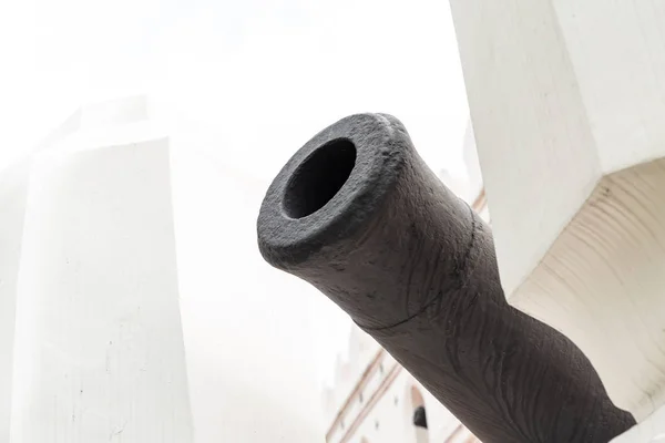 old iron barrel cannon black on a white fort background protective weapon