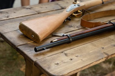 medieval weapon musket butt and smoothbore muzzle on a wooden table