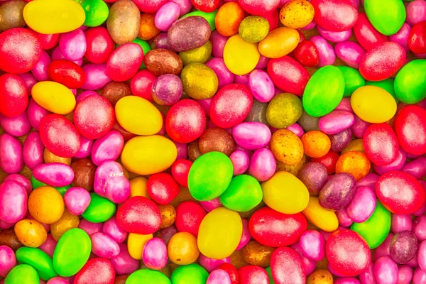 彩色巧克力糖果的背景果冻豆粉红色 黄色和绿色 — 图库照片