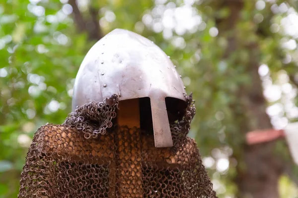 forged helmet of a medieval warrior and chain mail try rusty