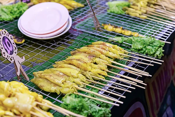 fresh marinated squid on bamboo skewer asia street food