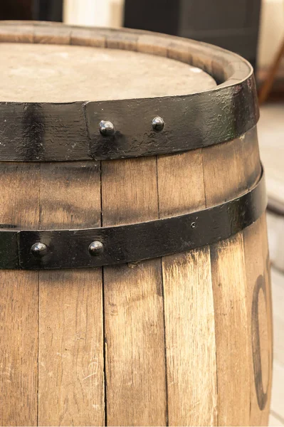 light beige oak barrel with a hoop close-up vertically close-up