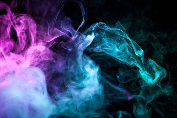 Colorful pink and blue a smoke on a black isolated background. Background from the smoke of vape