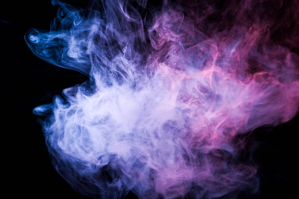 Colorful pink and blue smoke  on a black isolated background. Background from the smoke of vap