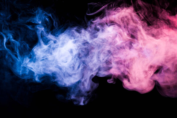 Colorful pink and blue smoke  on a black isolated background. Background from the smoke of vap