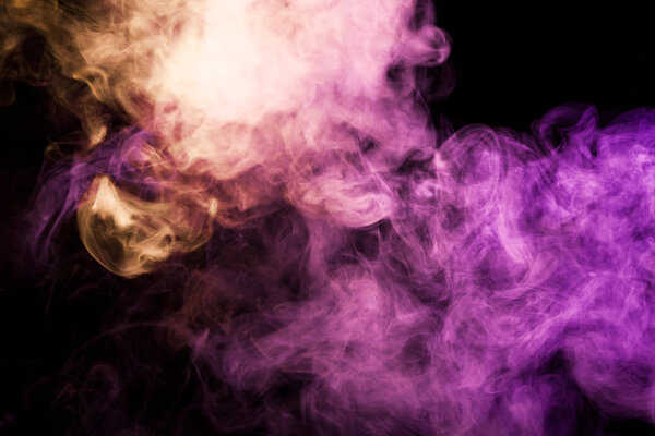 Dense multicolored smoke of pink and red colors on a black isolated background. Background of smoke vape
