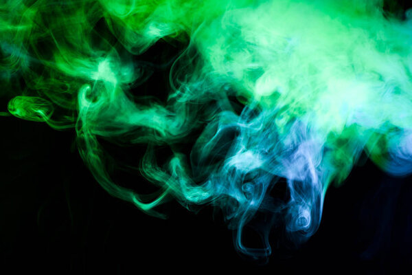 Blue and green smoke on black backgroun