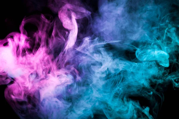 Pink and  blue cloud of smoke of  black isolated background. Background from the smoke of vap