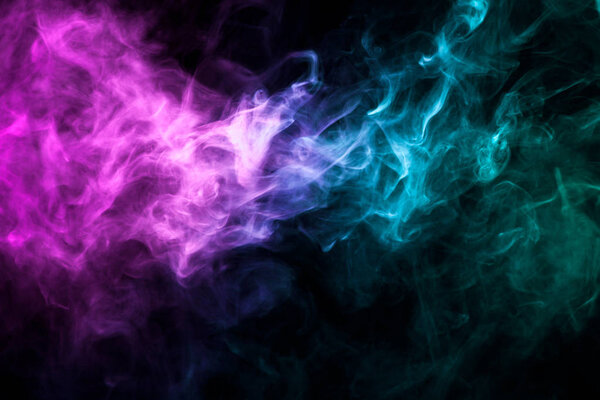 Pink and blue cloud of smoke of black isolated background. Background from the smoke of vap