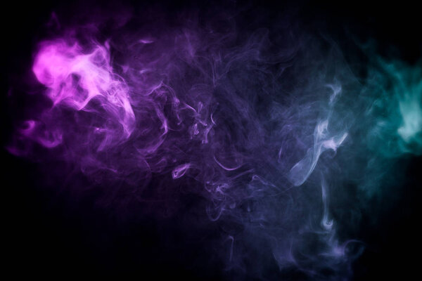 Pink, purple and blue cloud of smoke of black isolated background. Background from the smoke of vap