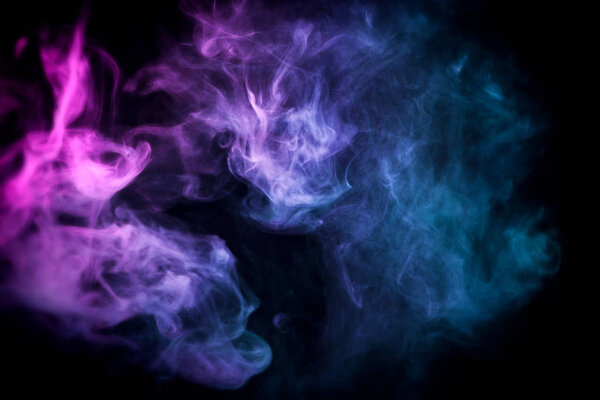 Cloud of blue and pink smoke on a black isolated background. Background from the smoke of vap