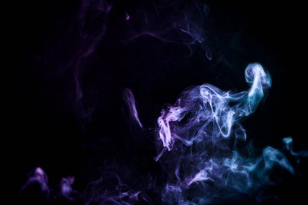 Dense multicolored smoke of pink and blue colors on a black isolated background.